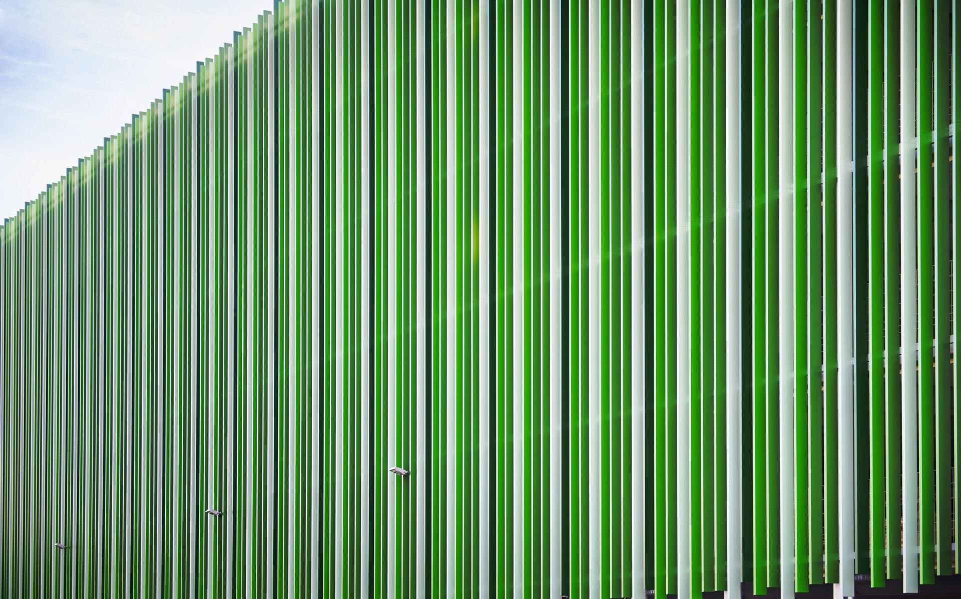 Green striped facade of a parking garage