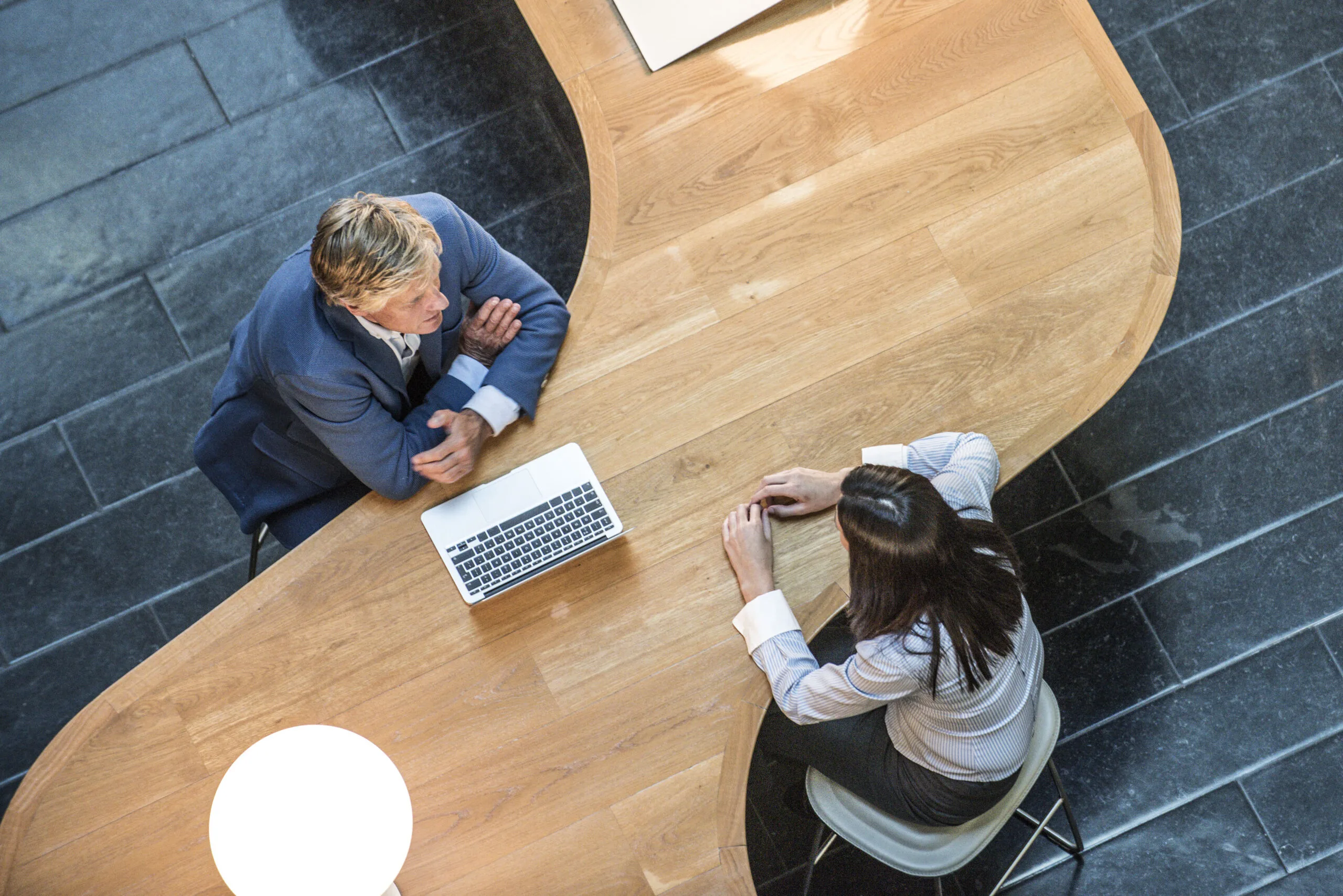 Two professionals discussing a hiring opportunity across a table